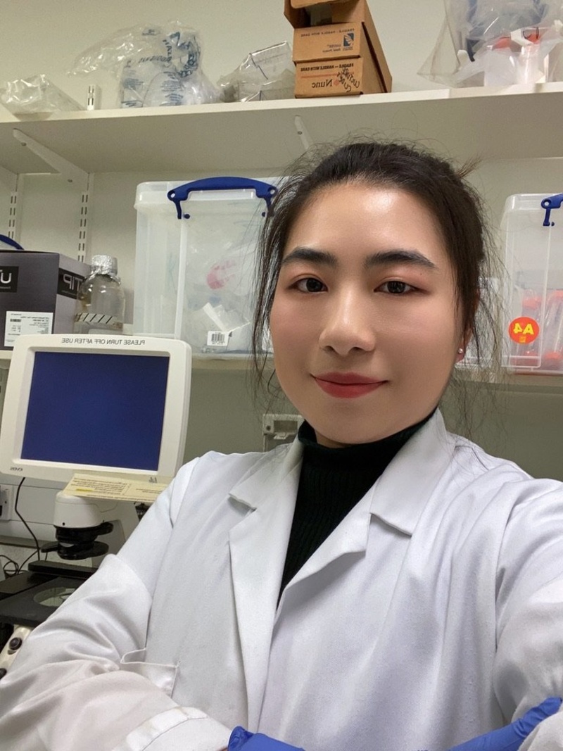 A woman in her lab coat