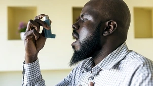 Person using a blue inhaler