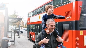 Parent and child next to bus