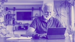 Old man browsing through his tablet