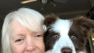 A woman holding a dog