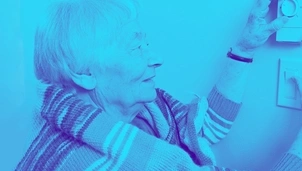 Old woman regulating the thermostat