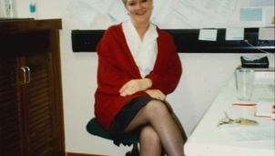 A woman sat on a desk chair in her office