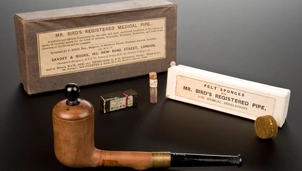 A vintage medical inhalation pipe set, including Mr. Bird's Registered Medical Pipe, felt sponges, and medicinal containers for treating respiratory conditions