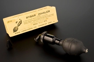 Vintage Rybar pocket inhaler with a black rubber bulb and nozzle, used for fine mist medication delivery