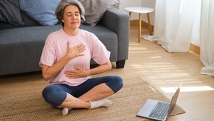 woman sat cross legged examining her breathing
