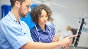 Two doctors looking at a screen in a hospital