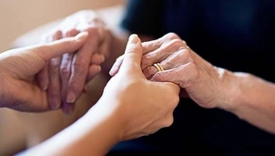 Two people holding hands