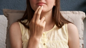 woman tapping her chin