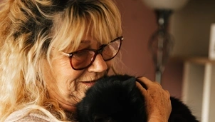 Woman cuddling puppy