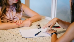 Two people sitting at a table talking