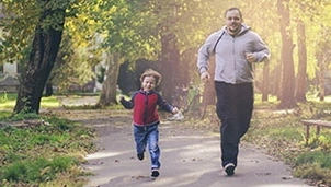 Parent and child running outside