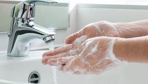 Person washing their hands with soap