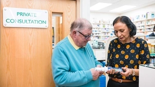 Pharmacist with her patient and an inhaler