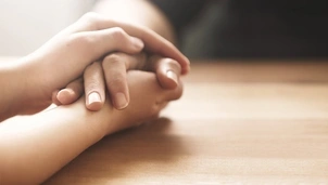 Two people holding hands